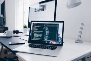 Top 10 Essential Questions to Ask a Business Information Systems Professional During an Interview Laptop with Code
